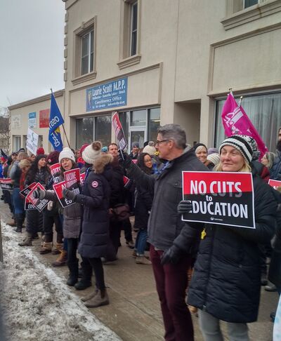 Dozens protest against education cuts in front of Laurie Scott's office